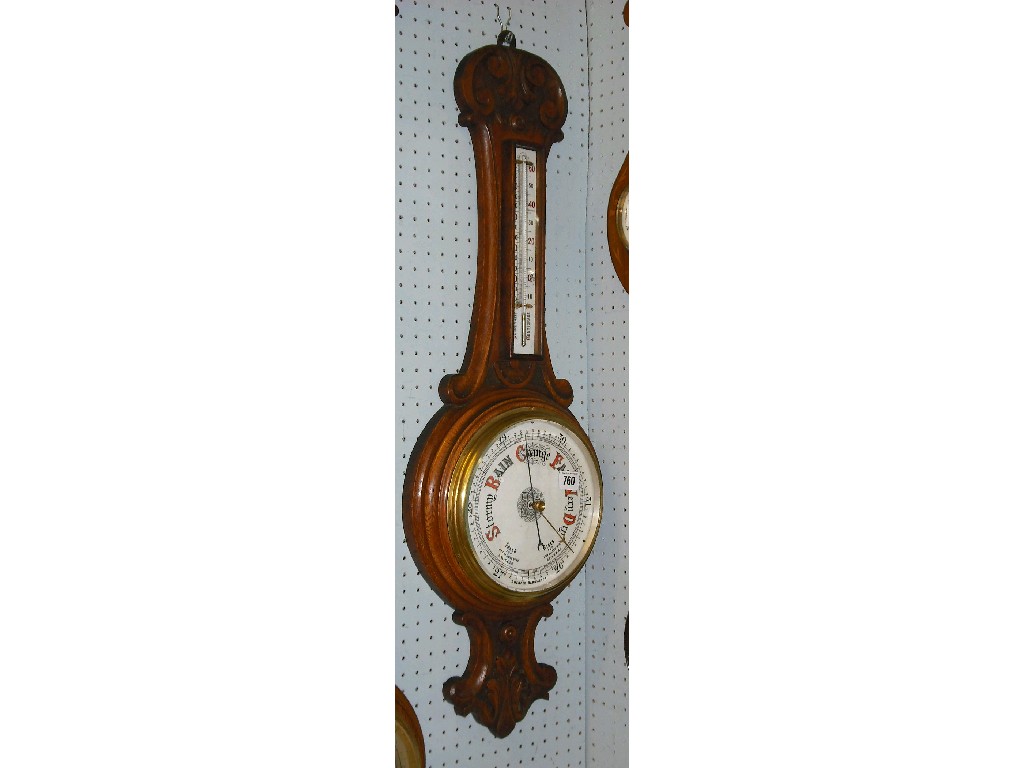 Appraisal: Oak wheel aneroid barometer thermometer the dial within a turned