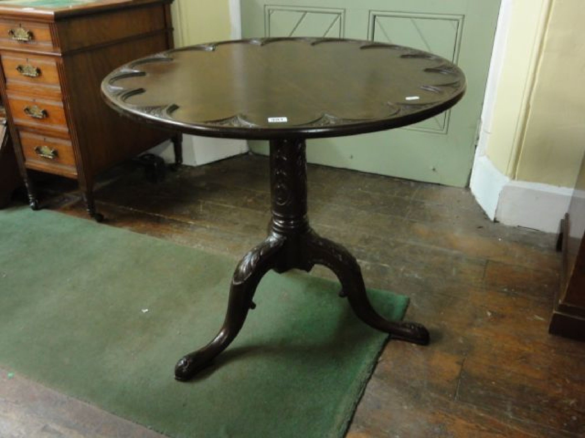 Appraisal: A Georgian mahogany supper table with scalloped top carved column