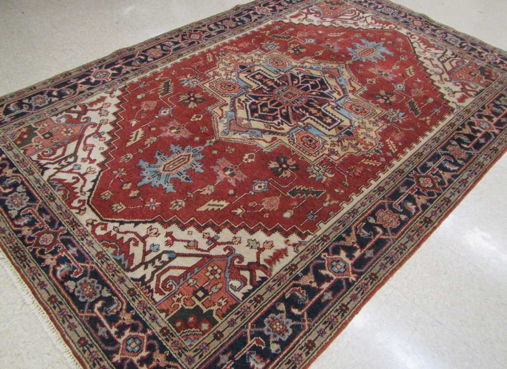 Appraisal: HAND KNOTTED ORIENTAL CARPET Persian Serapi design composed of central