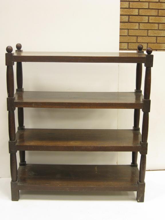 Appraisal: An Edwardian oak four tier Dumb Waiter with spherical finials