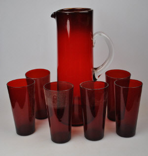 Appraisal: An Edwardian ruby glass lemonade set comprising jug and six