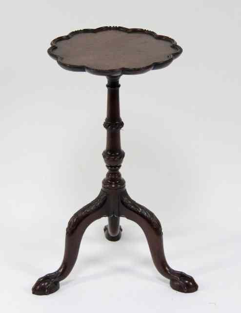 Appraisal: A George III mahogany urn stand on a carved knopped