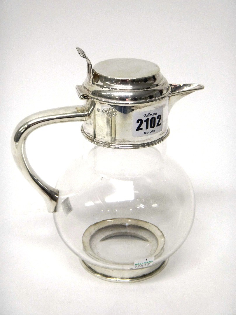 Appraisal: A Victorian silver mounted globular glass claret jug having a