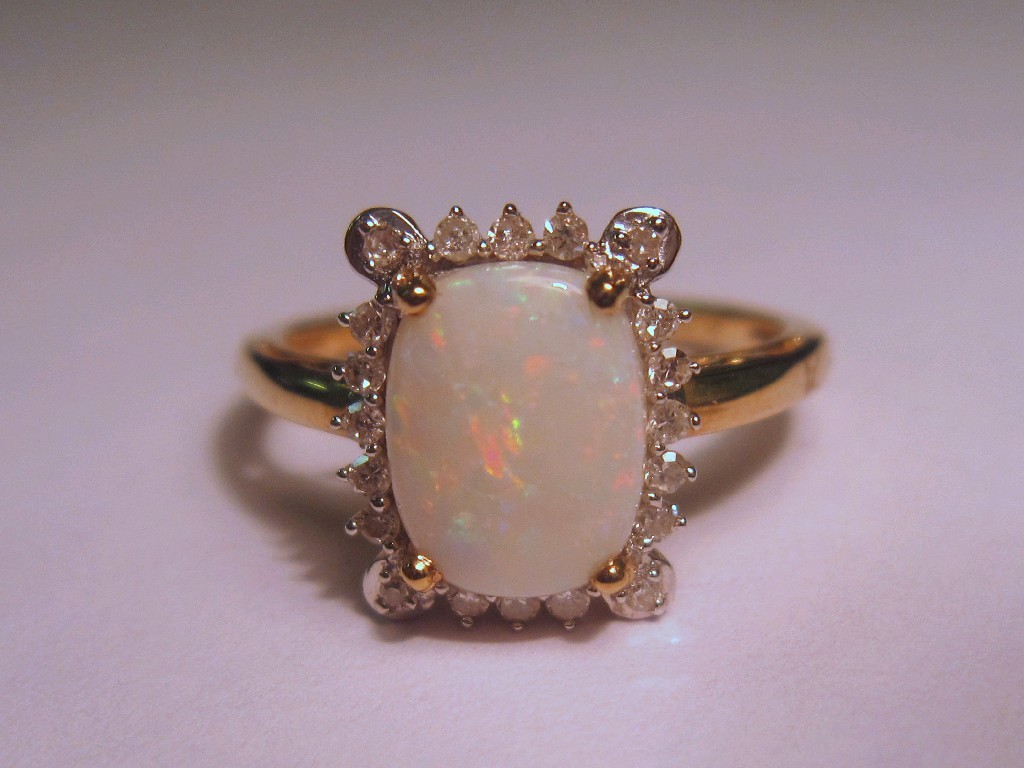 Appraisal: Nine carat gold opal and diamond cluster ring