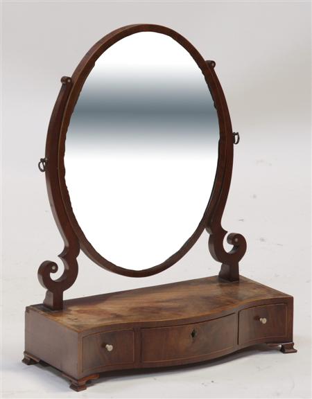 Appraisal: A th century mahogany serpentine dressing mirror the oval mirrored