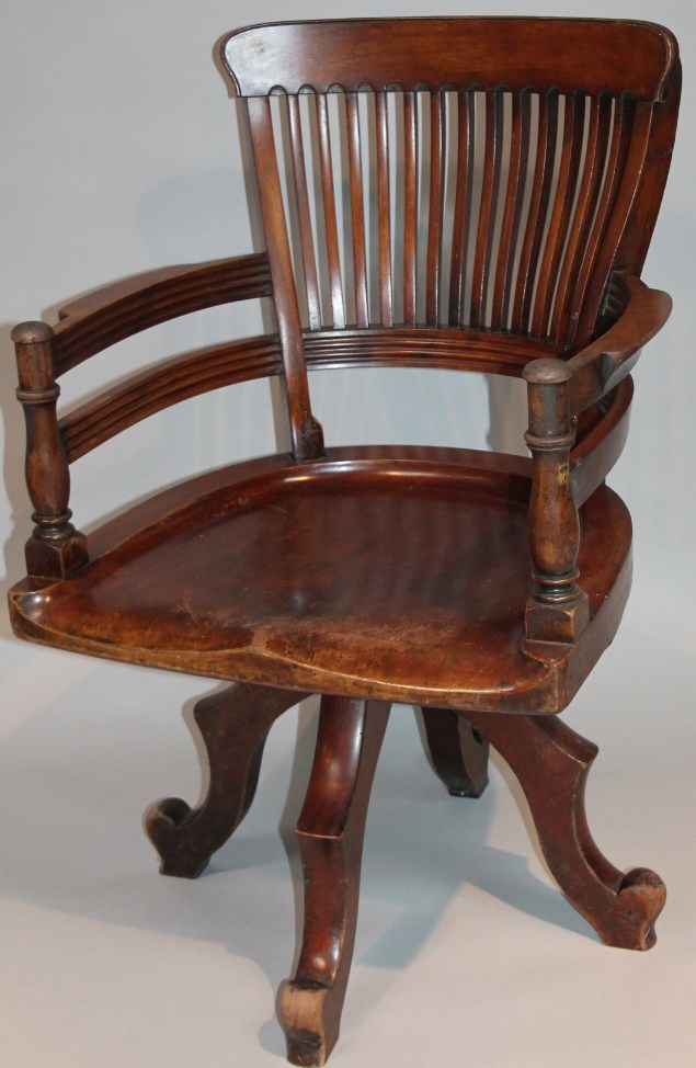 Appraisal: A 's mahogany stained office chair with a pierced horizontal