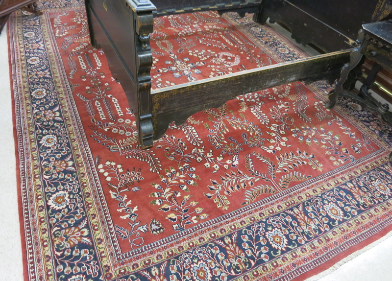 Appraisal: HAND KNOTTED ORIENTAL CARPET a red field Indo-Sarouk with floral