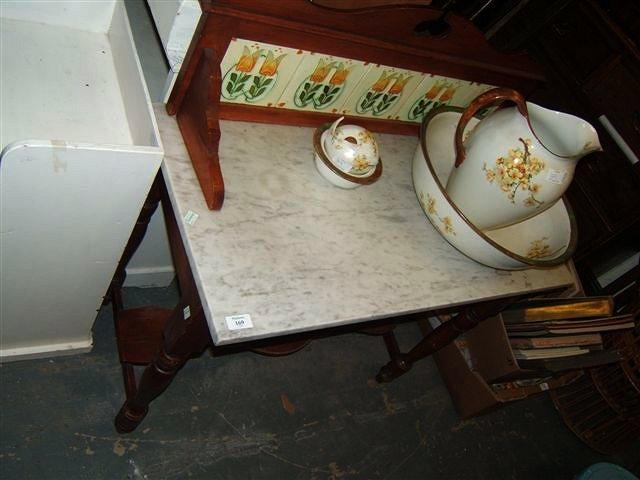 Appraisal: A Victorian mahogany wash stand with tile set back marble