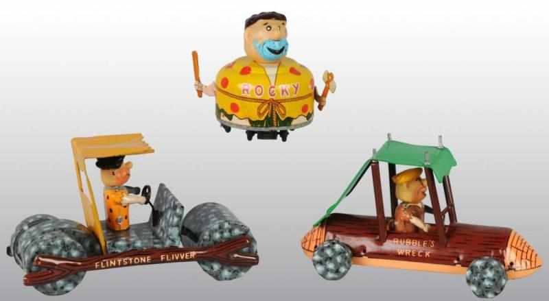 Appraisal: Lot of Tin Flinstones Toys Description Friction and battery-operated All