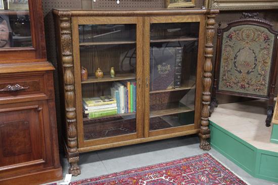 Appraisal: BOOKCASE Oak having two large glazed doors flanked by turned