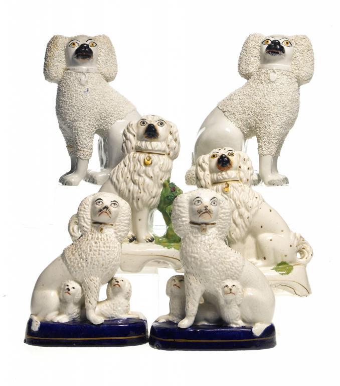 Appraisal: THREE PAIRS OF STAFFORDSHIRE EARTHENWARE MODELS OF DOGS one with