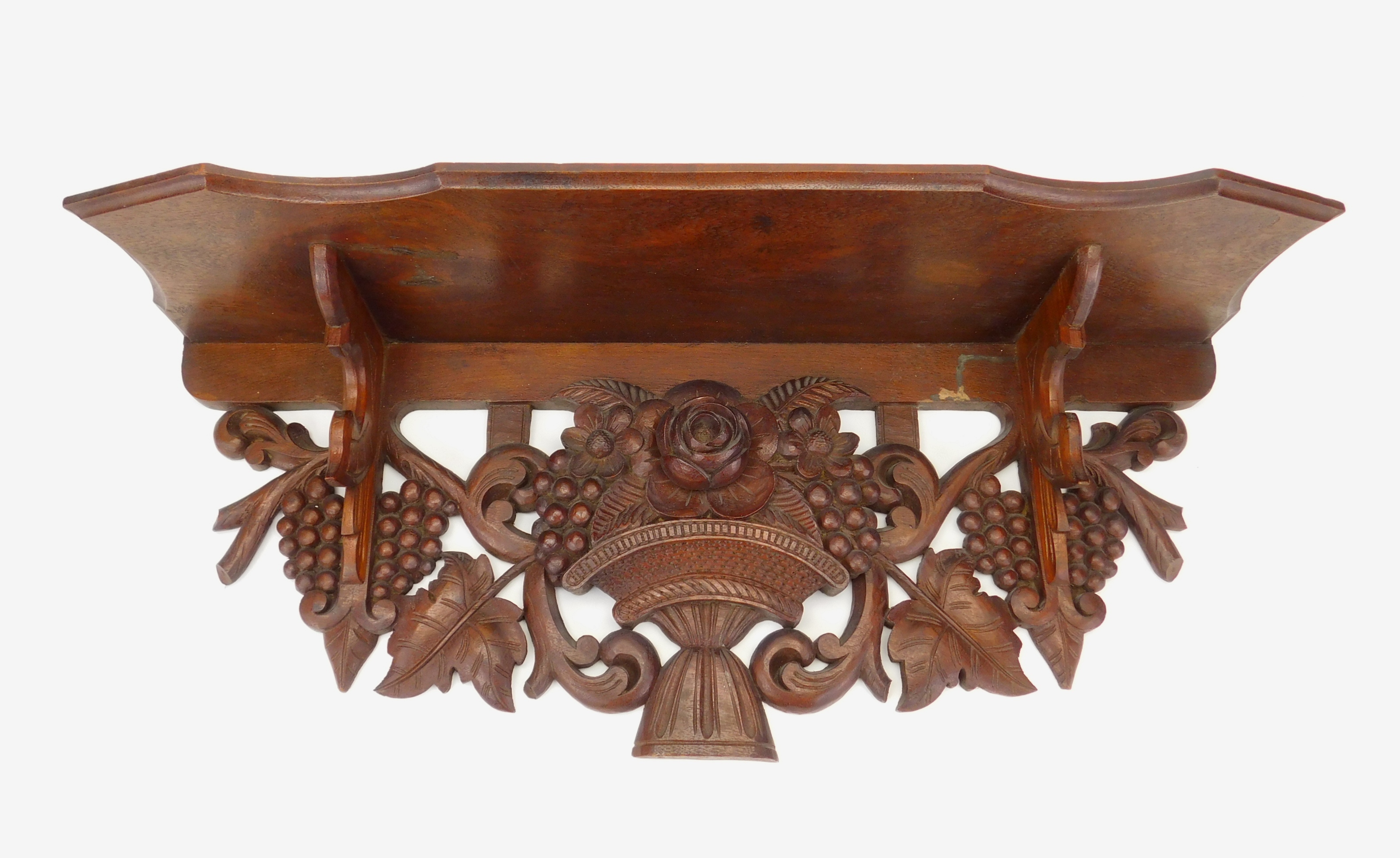 Appraisal: Victorian carved walnut clock shelf central carved basket with flowers