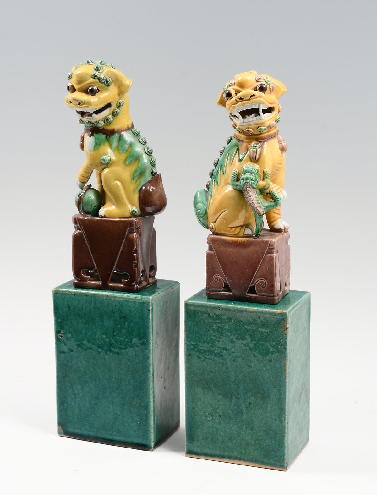 Appraisal: PAIR SEATED CHINESE PORCELAIN FOO DOGS ON STANDS Set of