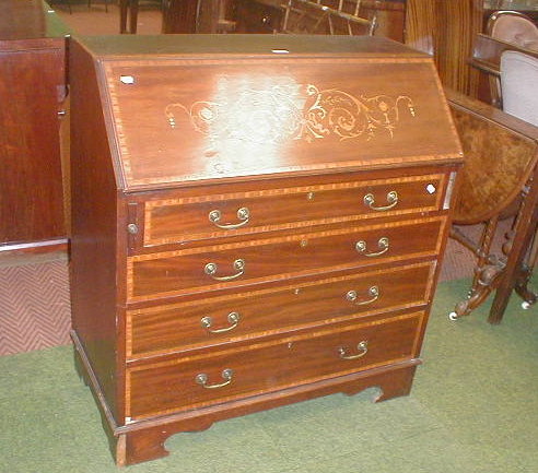 Appraisal: An Edwardian mahogany marquetry bureau with fall flap resting on