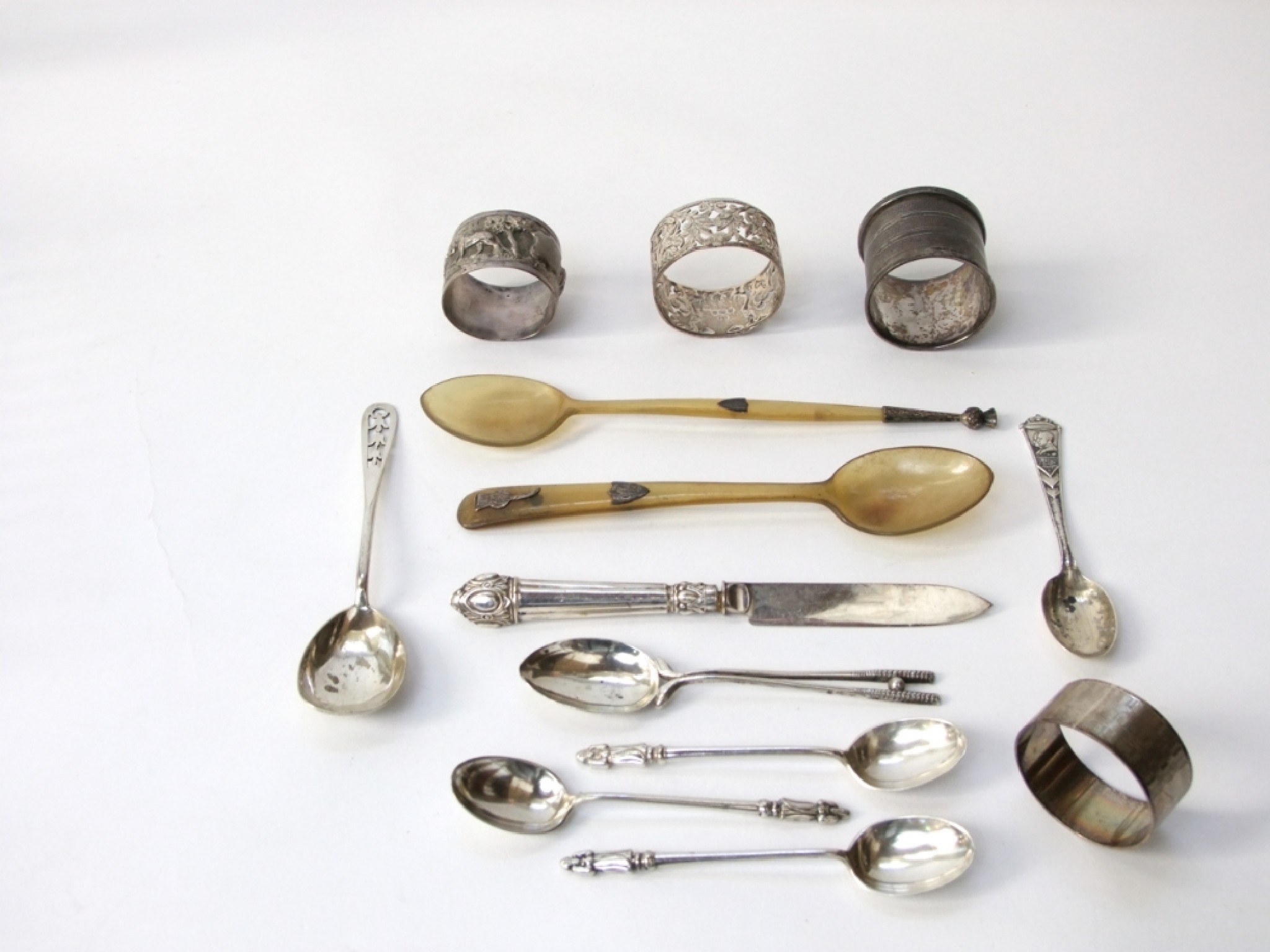 Appraisal: Four silver napkin rings and a silver teaspoon together with