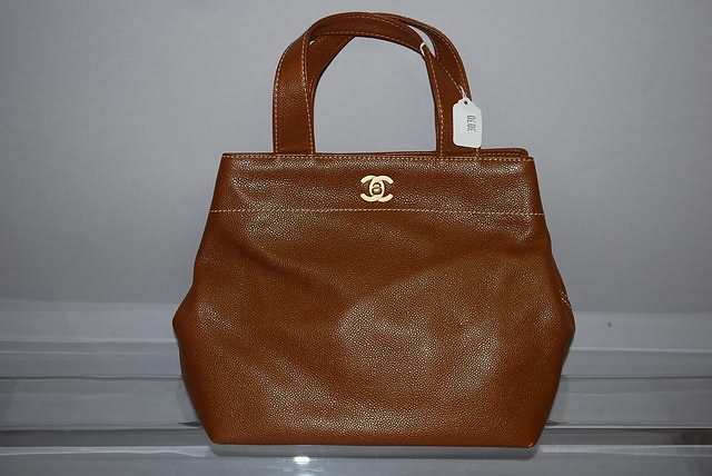 Appraisal: Chanel medium brown leather handbag with shoulder strap and tan