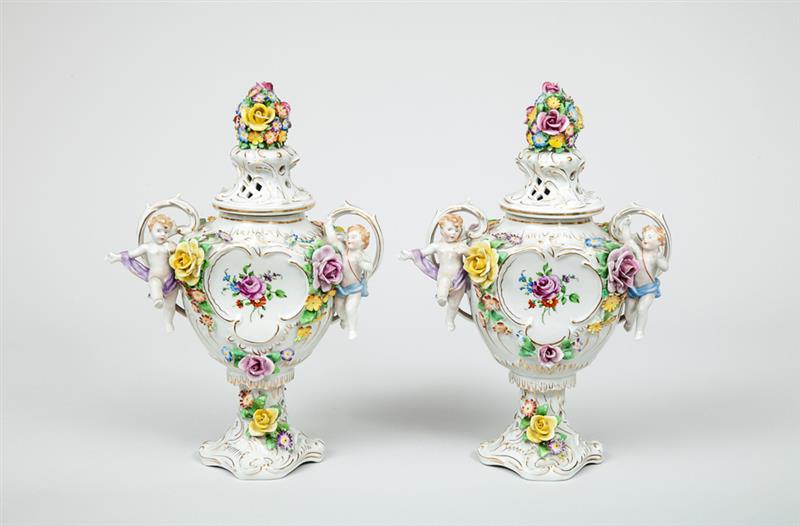 Appraisal: Pair of Shierholz Floral-Encrusted Porcelain Vases With putti handles x