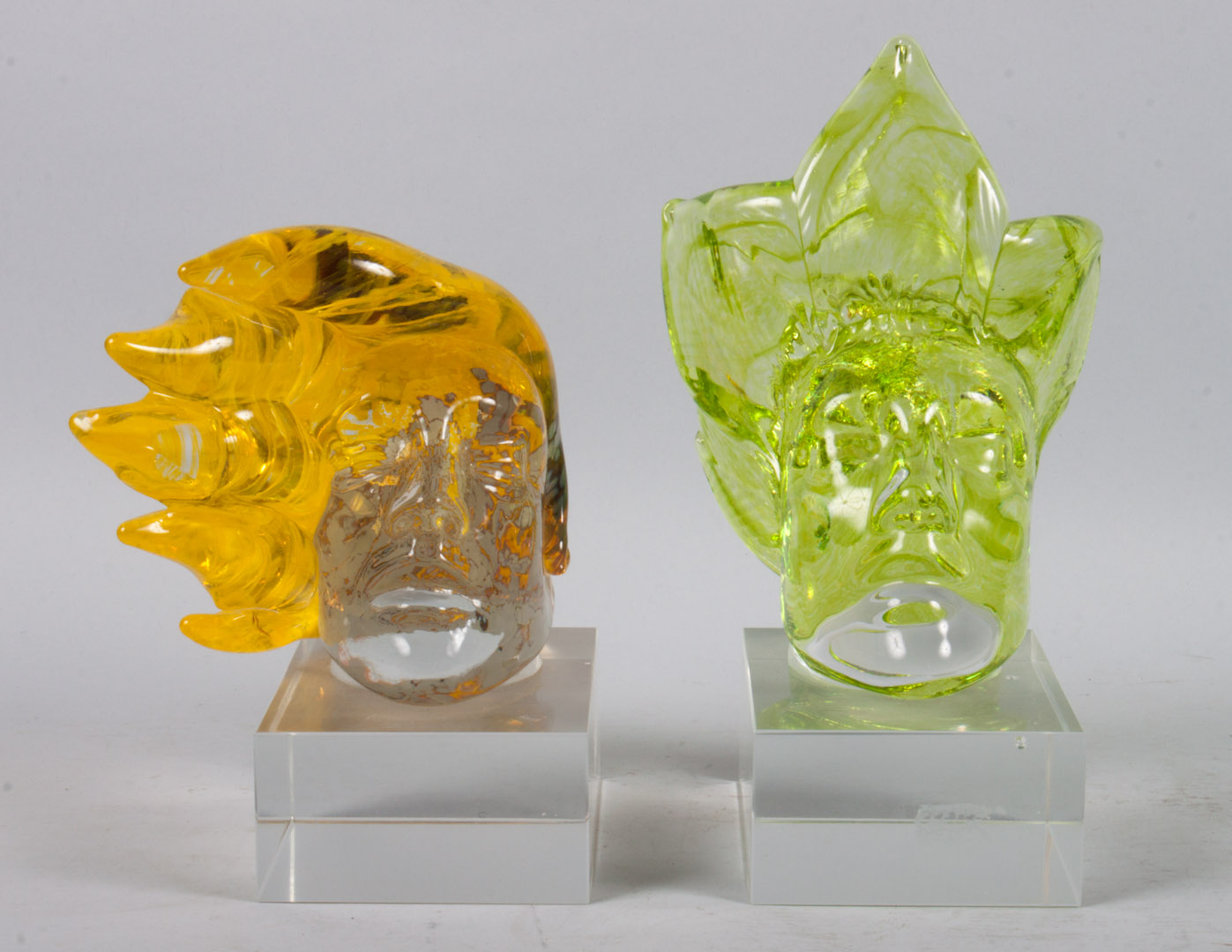 Appraisal: Two glass sculpture heads stylized color and colorless glass heads