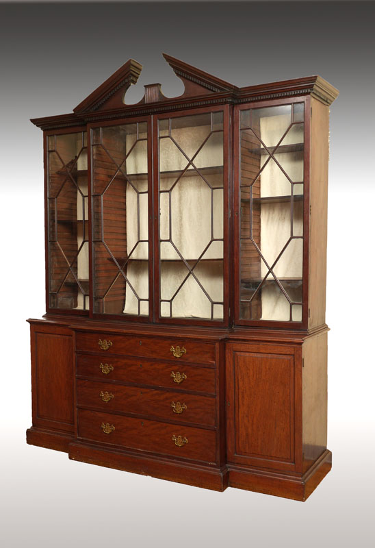 Appraisal: CHIPPENDALE STYLE MAHOGANY BREAKFRONT BOOKCASE th century architectural pediment over