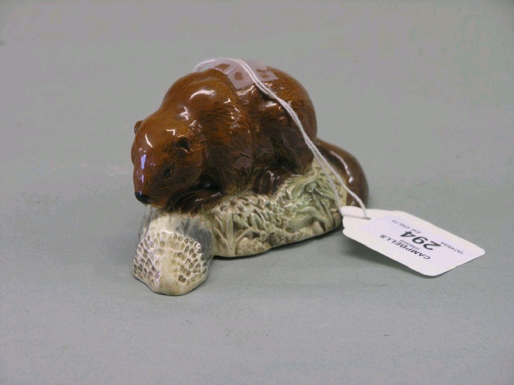 Appraisal: A Beswick Beaver on Log shape facing left tan designed