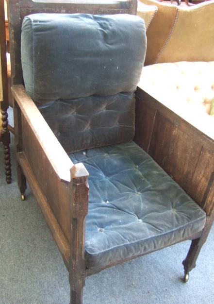 Appraisal: An oak Gothic Revival deep seated panel back chair with