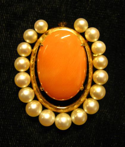 Appraisal: karat yellow gold coral and pearl broochOval coral surrounded by