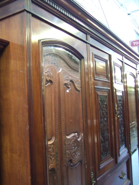 Appraisal: A Victorian walnut framed triple wardrobe the pair of central