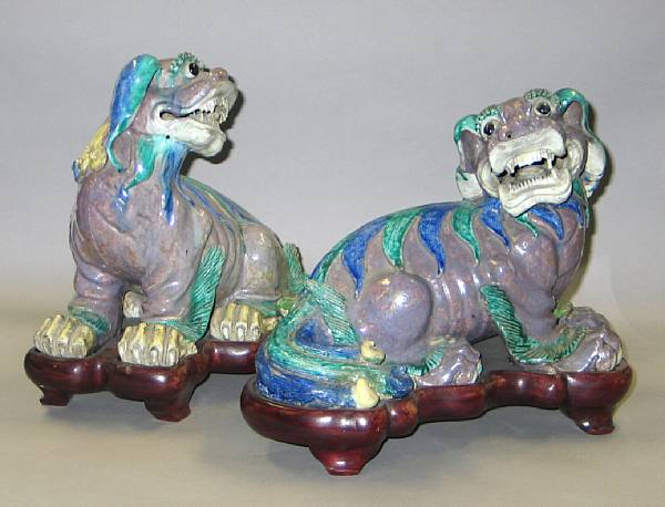 Appraisal: A pair of polychrome enameled porcelain crouching lions minor old