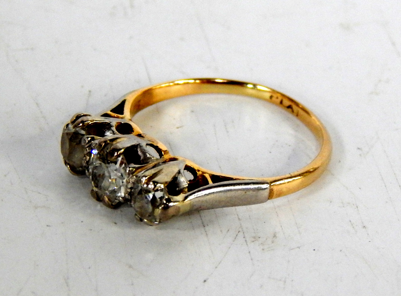 Appraisal: A three stone diamond half hoop ring with platinium claw