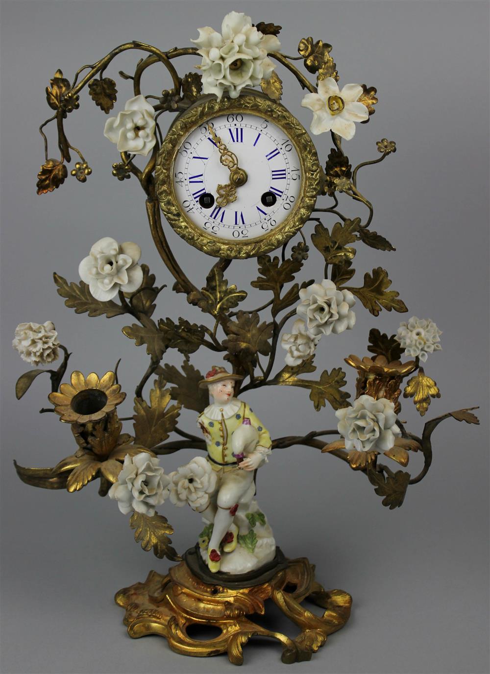 Appraisal: FRENCH PORCELAIN MOUNTED ORMOLU FIGURAL MANTEL CLOCK mid- th Century