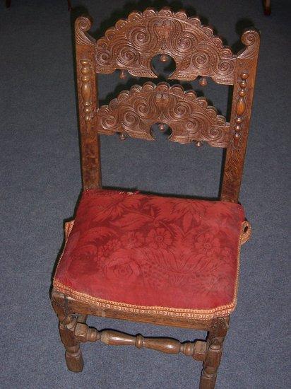 Appraisal: A Derbyshire oak single chair with twin carved horizontal arch