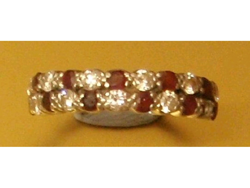 Appraisal: A ruby and diamond half-hoop ring with two bands of