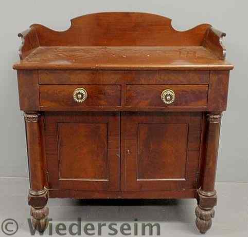 Appraisal: Empire mahogany cabinet with carved backsplash two drawers over two