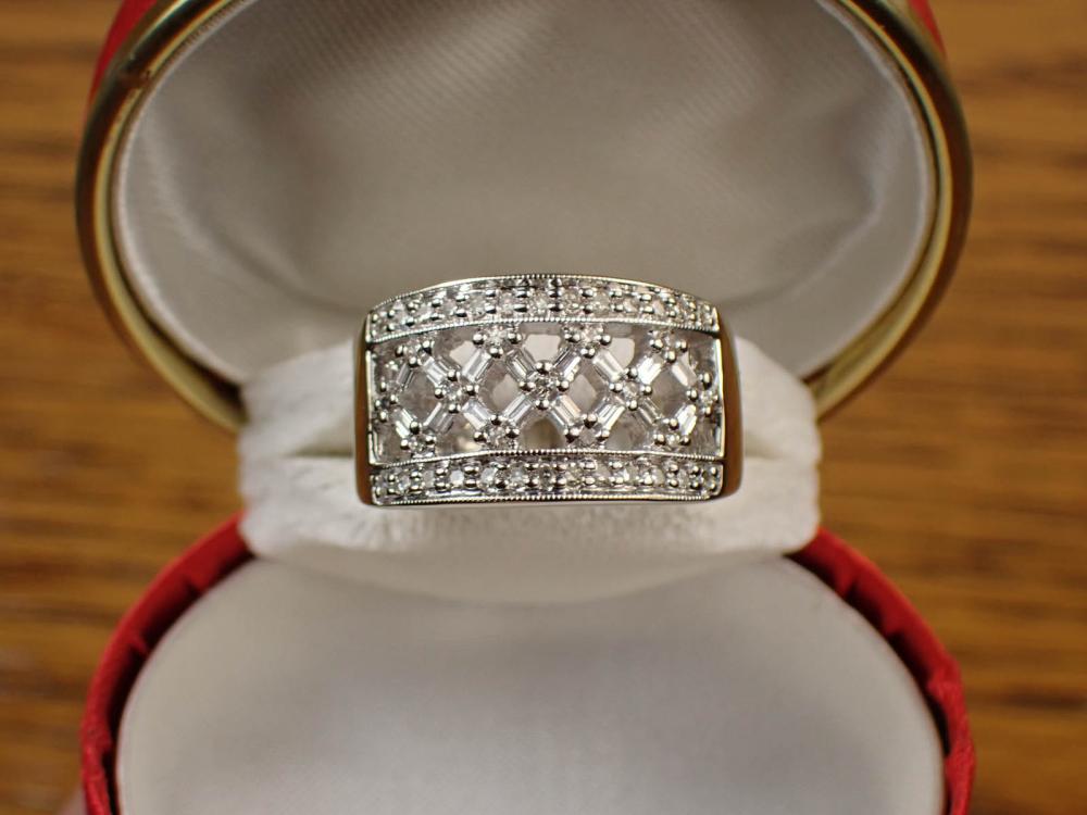 Appraisal: DIAMOND AND FOURTEEN KARAT WHITE GOLD RING The wide k