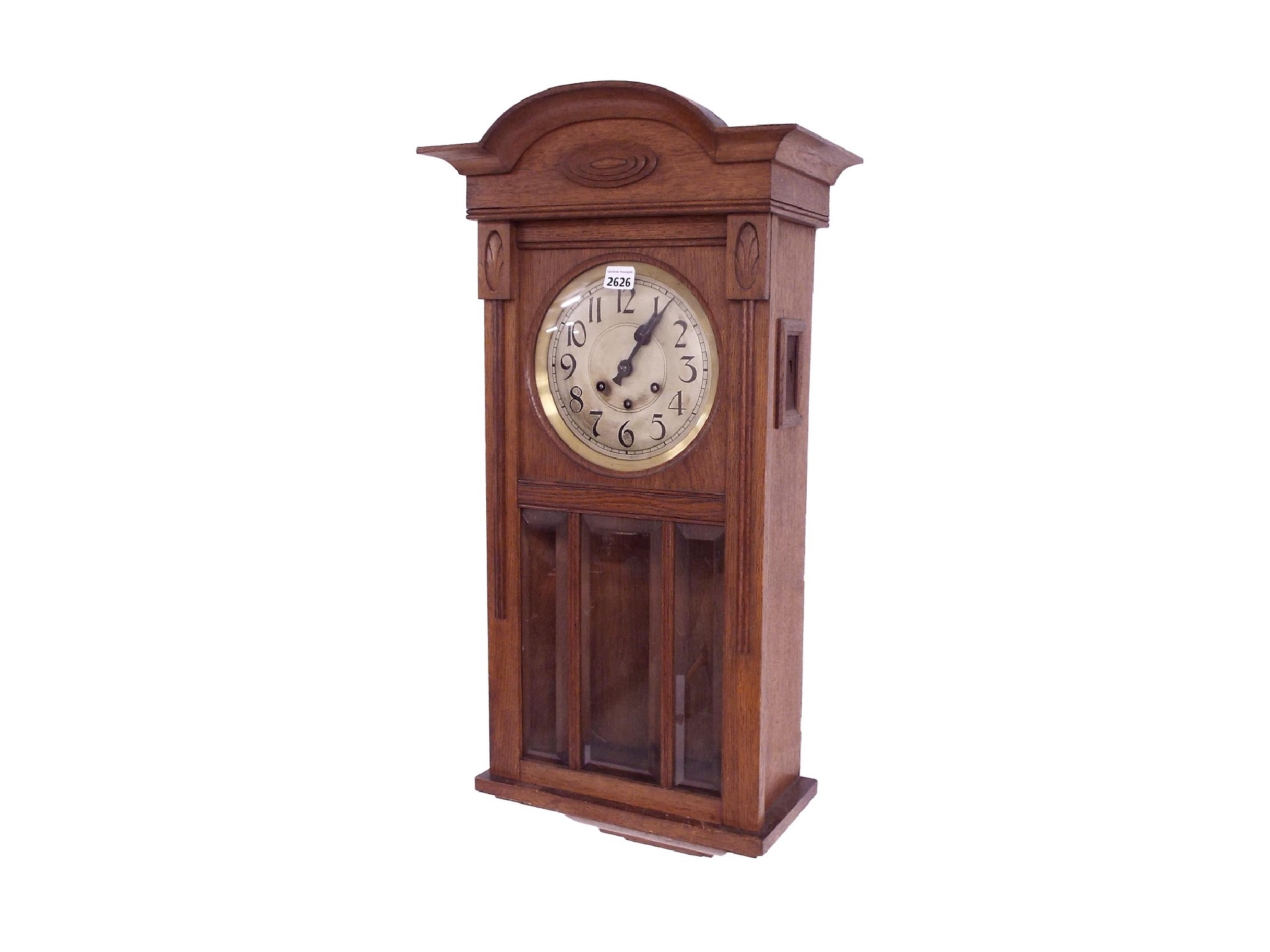 Appraisal: Oak three train wall clock the silvered dial over a