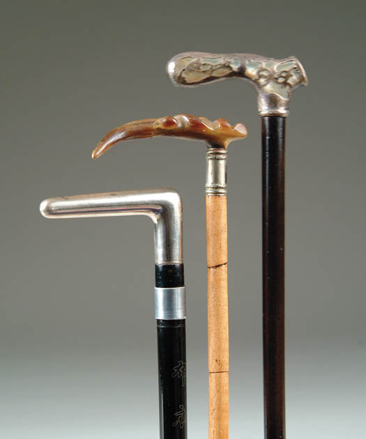 Appraisal: THREE L-HANDLED CANES - carved horn handle with German silver