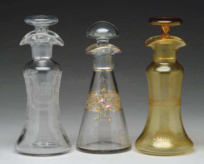 Appraisal: THREE CRUETS Citron glass bottle with matching stopper having an