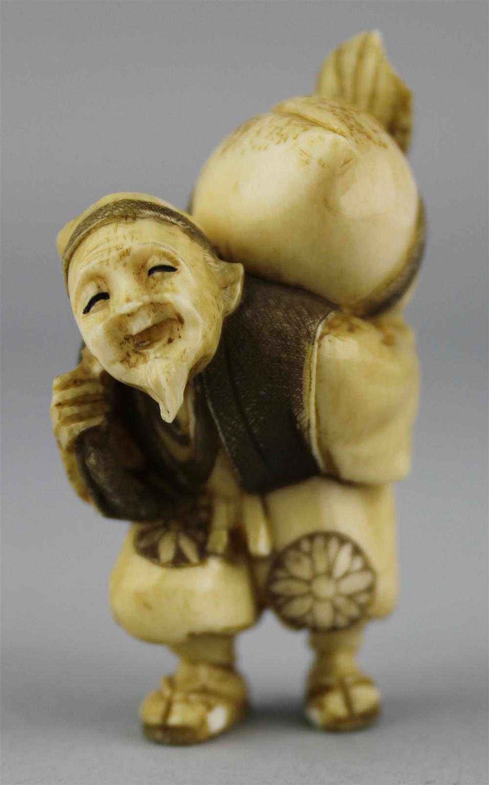 Appraisal: IVORY NETSUKE OF A MAN WITH A GIANT PEACH ON