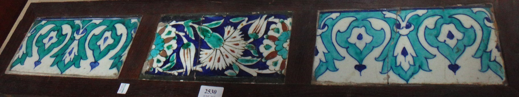 Appraisal: A panel of three Iznik rectangular border tiles and a