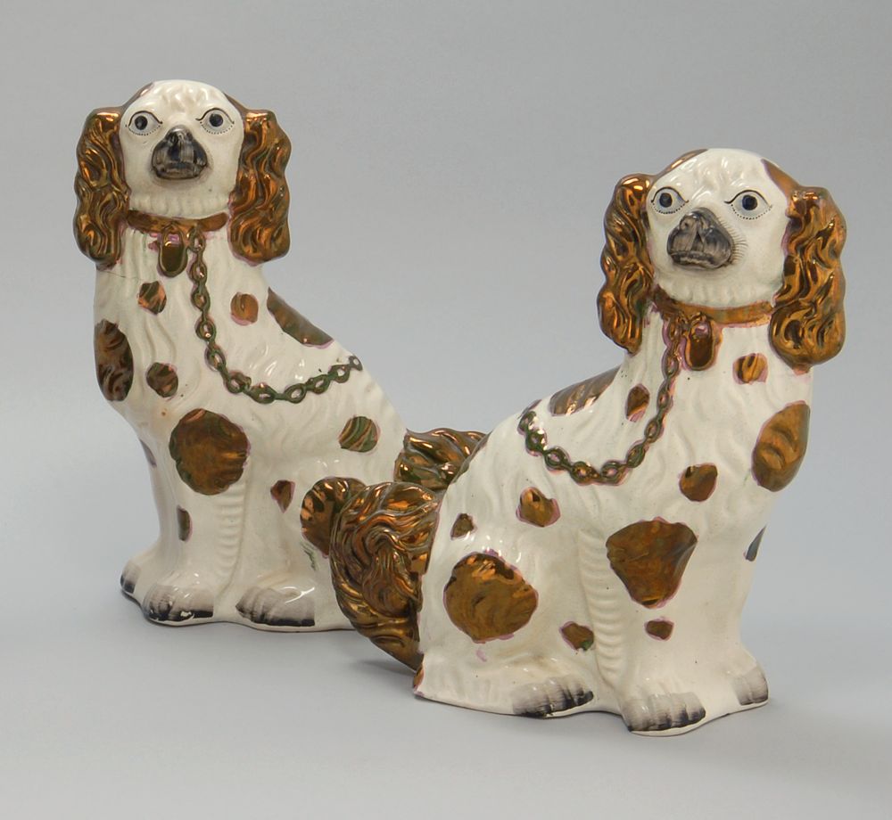 Appraisal: PAIR OF ANTIQUE ENGLISH STAFFORDSHIRE DOGS With copper luster highlights