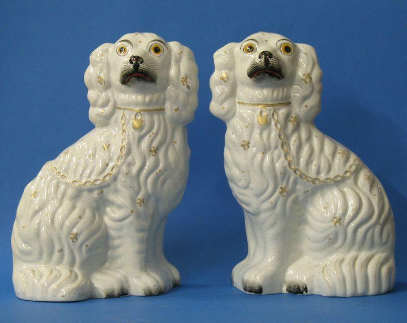 Appraisal: A PAIR OF STAFFORDSHIRE POTTERY SPANIEL DOGS the moulded bodies