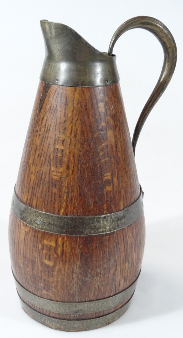 Appraisal: An early thC oak coopered jug with metal banding plain