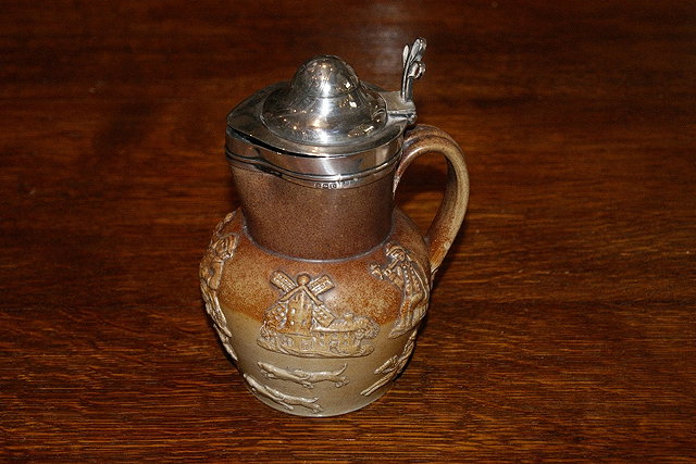 Appraisal: A Stoneware lidded tankardwith silver cover dated cm high