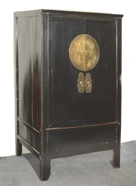 Appraisal: A CHINESE WARDROBE enclosed by two panel doors with applied