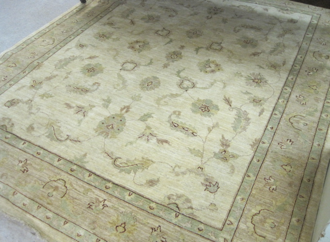 Appraisal: PAKISTANI PERSIAN CARPET floral design on khaki ground hand knotted