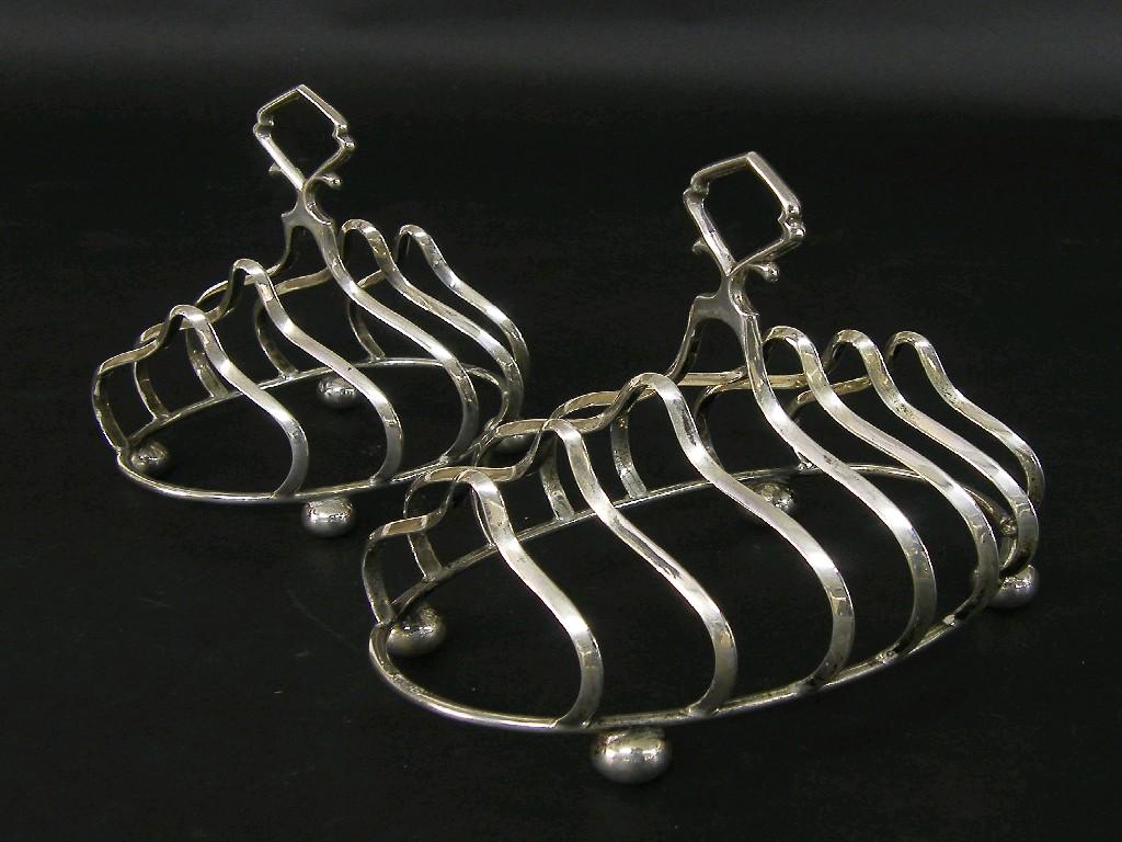 Appraisal: Pair of Mappin Webb silver graduated serpentine toast racks with