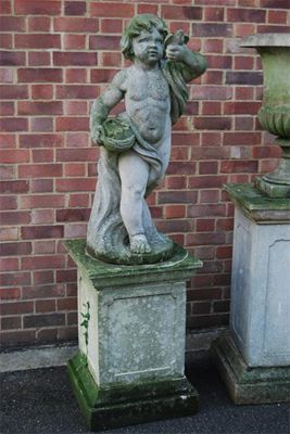 Appraisal: A reconstituted stone garden figure of a young boy holding