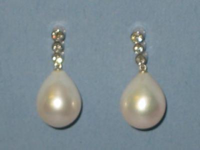 Appraisal: A PAIR OF CULTURED PEARL AND DIAMOND EARRINGS the large