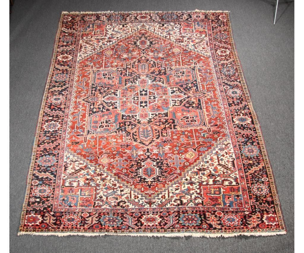 Appraisal: Room size Heriz carpet with overall geometric floral pattern on