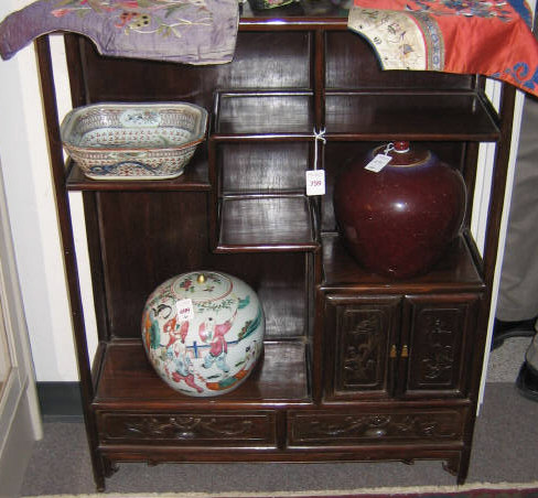 Appraisal: CHINESE HARDWOOD DIMINUTIVE SHELF With open shelves and a pair